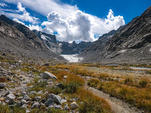 Free Stunning alpine landscape of Bregaglia Valley in Graubünden, Switzerland, with rocky terrain and cloudy sky. Stock Photo