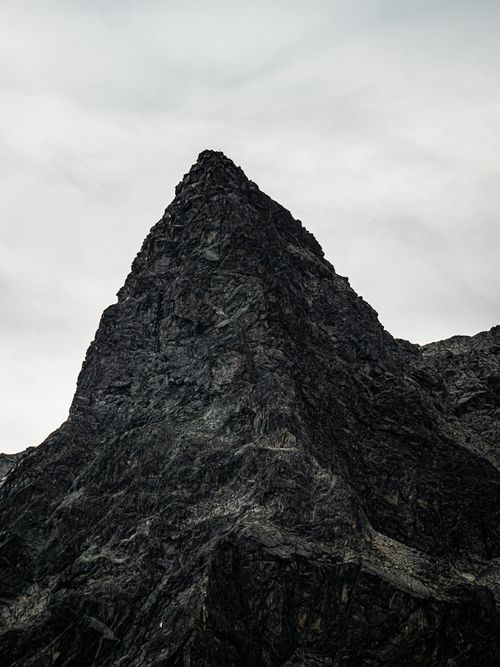 Free Stunning view of a rocky mountain peak in Bregaglia, Switzerland, under cloudy skies. Stock Photo