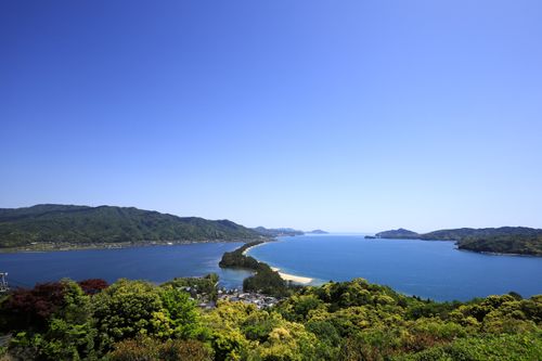 Free Stunning panoramic view of Amanohashidate in Miyazu, Kyoto, with lush greenery and blue ocean. Stock Photo