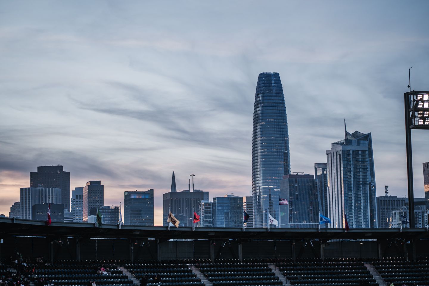 View from Oracle Park stands overlooking the San Francisco skyline with Salesforce Tower at dusk