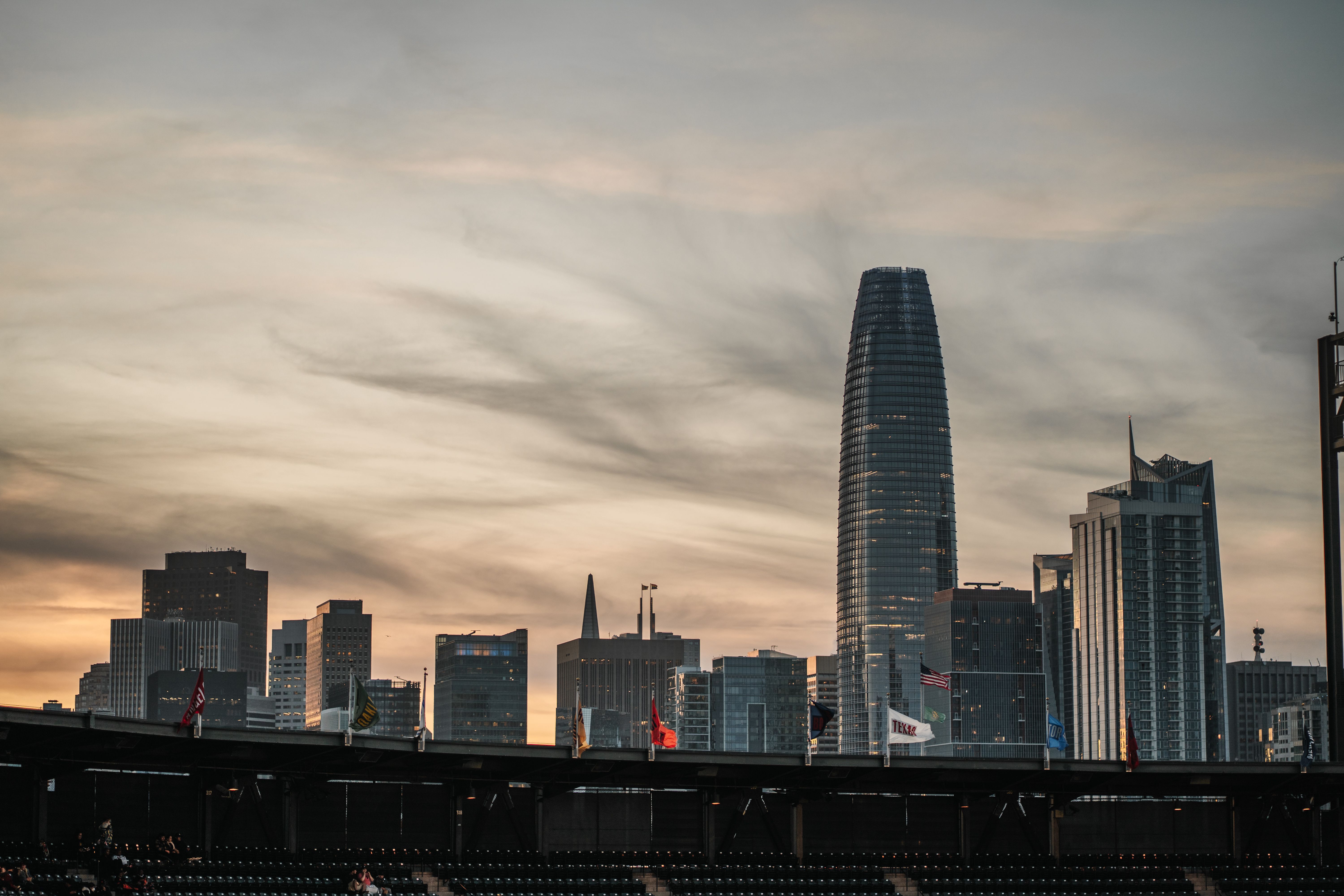 Capture of San Francisco skyline with iconic skyscrapers at dusk under a dramatic sky.
