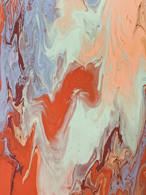 Free Captivating abstract water marbling artwork featuring vibrant red, orange, and blue swirls for creative inspiration. Stock Photo