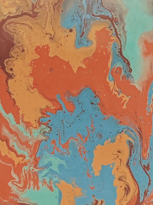 Free Dynamic abstract water marbling painting with vibrant orange, blue, and beige tones. Stock Photo