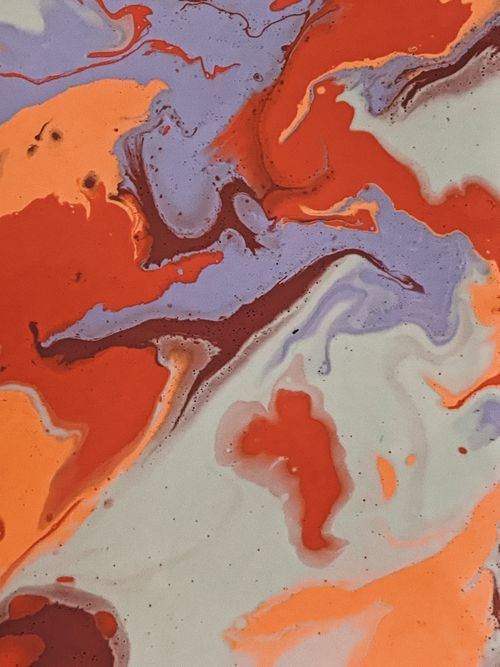 Free Colorful abstract marbled design with vibrant swirls of orange, red, and purple. Stock Photo