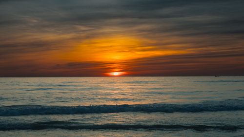 Free Stunning vibrant sunset over the ocean in Quảng Trị, Vietnam, with colorful sky reflection on water. Stock Photo