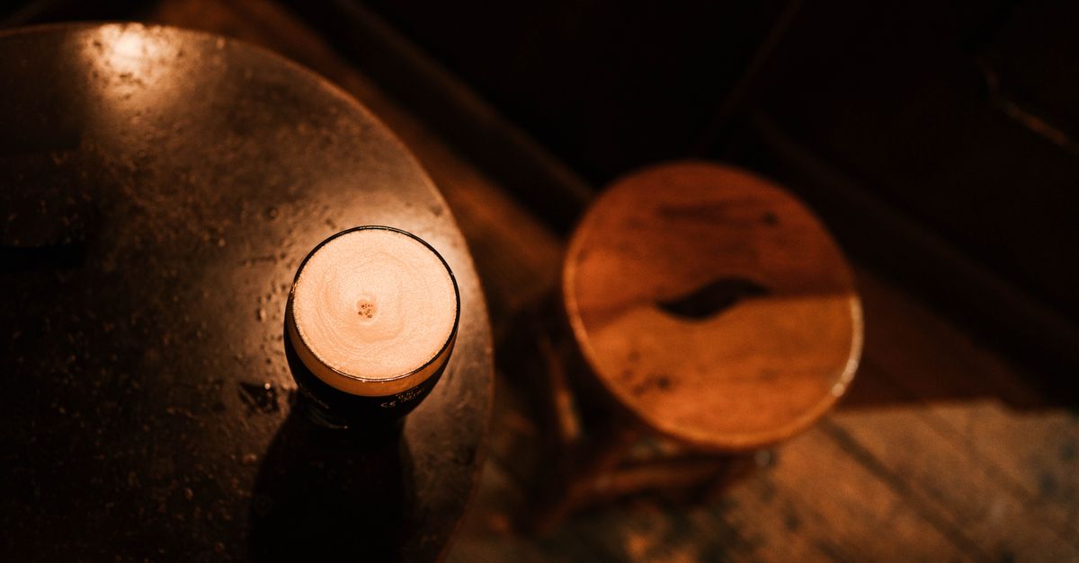 Warm, inviting atmosphere of a rustic cafe in Madrid featuring a freshly poured beverage on a wooden table.