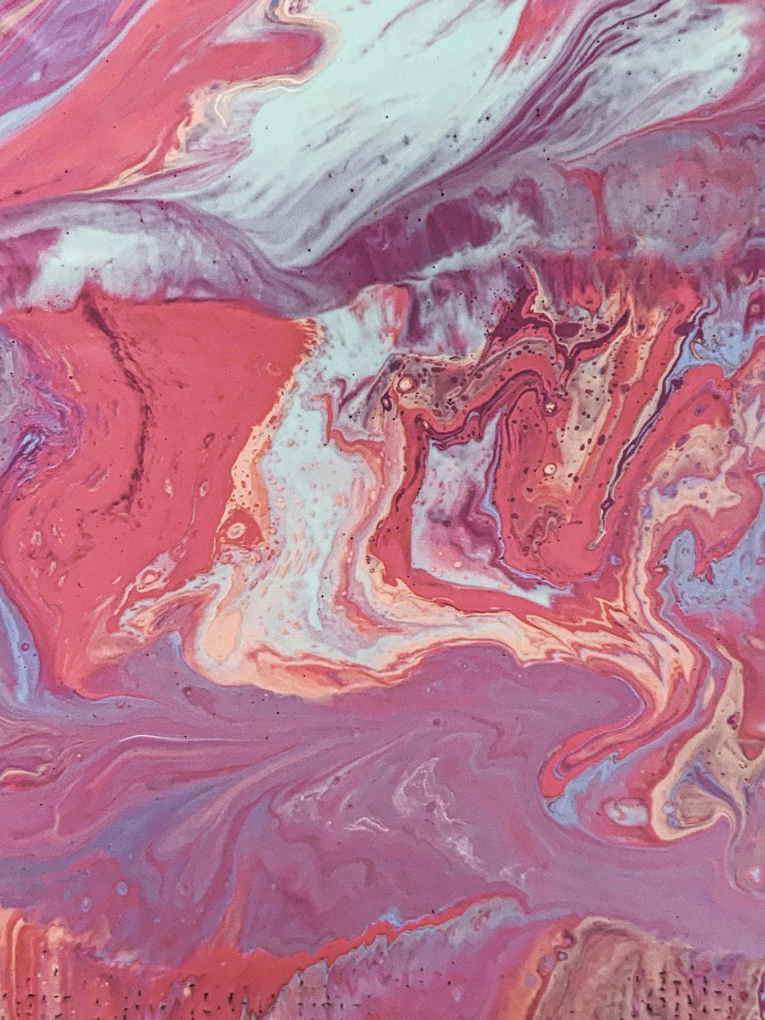 Swirling marbled colours floating on the surface of water