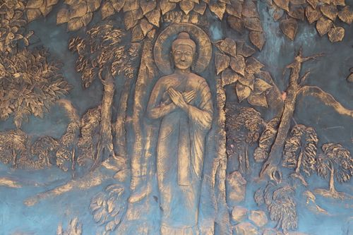 Free Intricate Buddha relief sculpture embellished with nature motifs, highlighting spiritual tranquility. Stock Photo