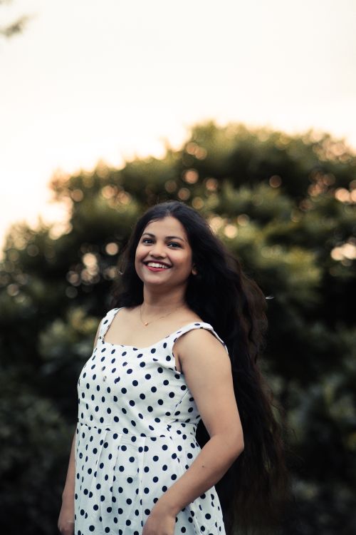 Free Cheerful woman posing in a polka dot dress amidst nature in Baripada, India. Stock Photo