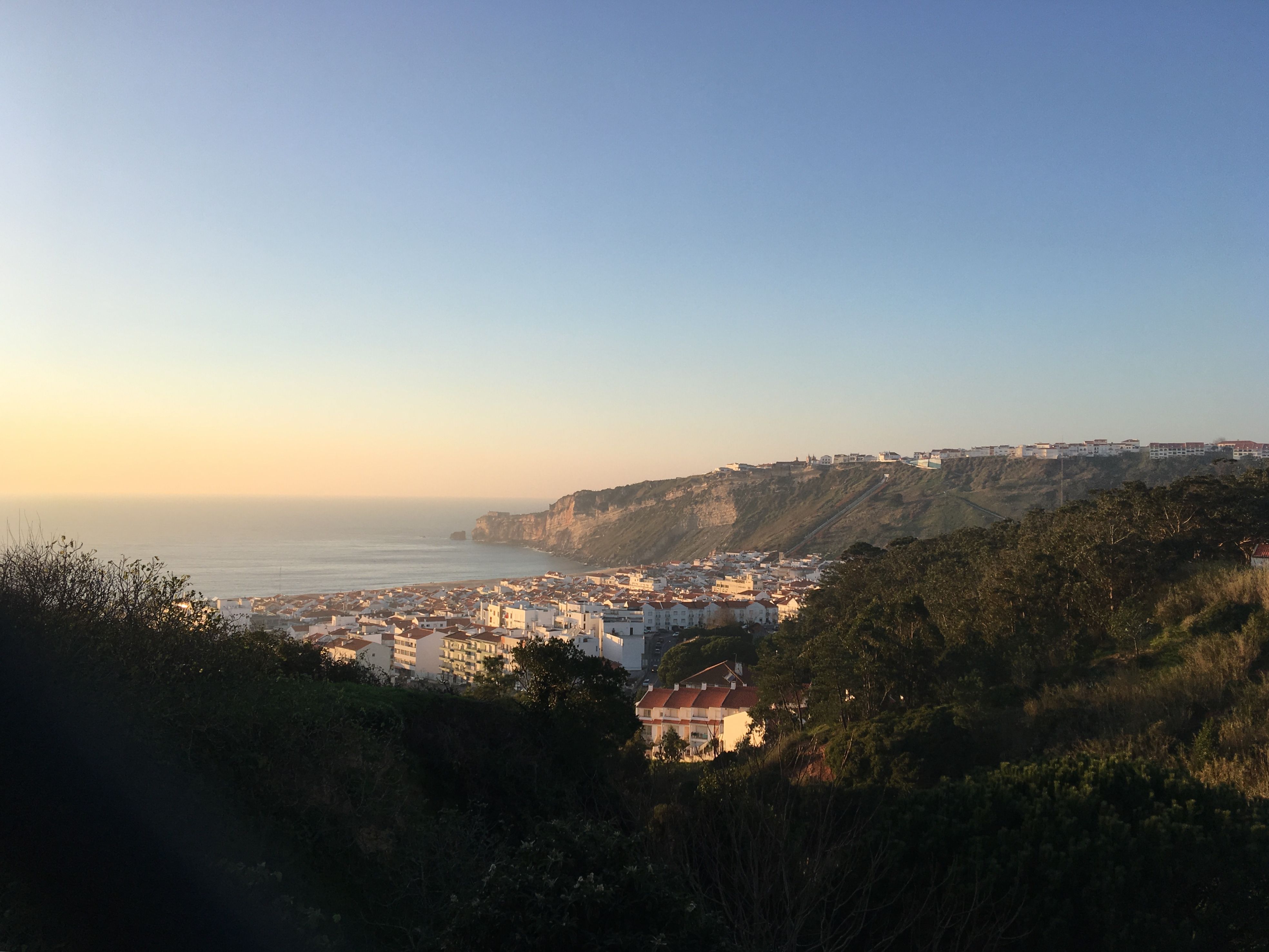 quiet luxury travel destination empty coastal village at golden hour