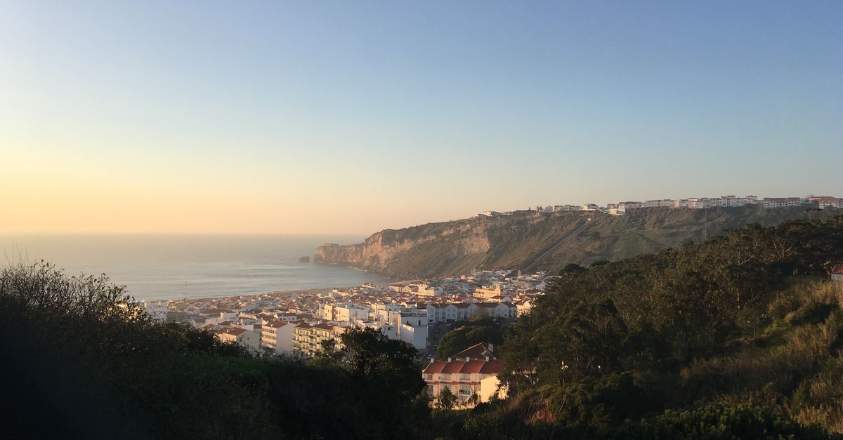 quiet luxury travel destination empty coastal village at golden hour