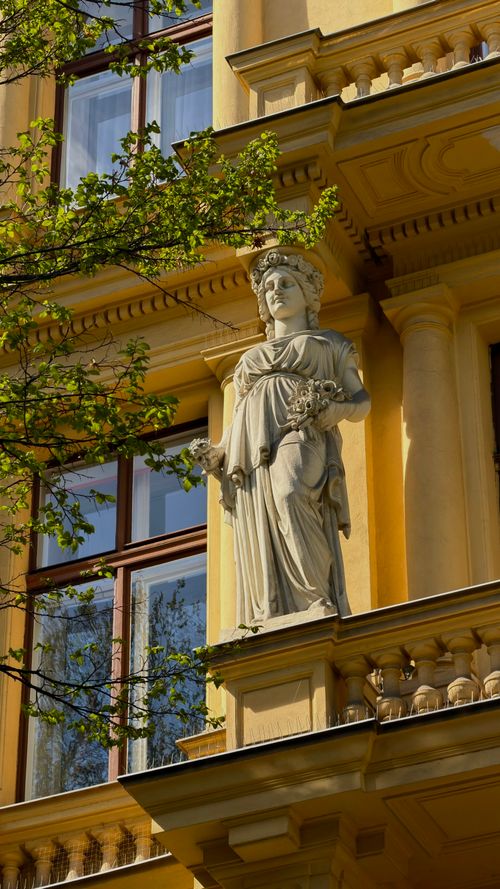 Free Beautiful statue and classic architecture on a building in Vienna, Austria, illuminated by warm sunlight. Stock Photo
