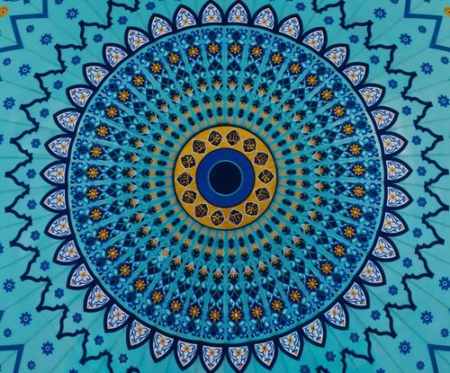 Free A vibrant circular Islamic art pattern featuring blue and gold hues in a Malaysian mosque ceiling. Stock Photo