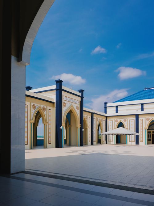 Free Beautiful Islamic mosque with intricate architecture and blue sky in Malaysia. Stock Photo