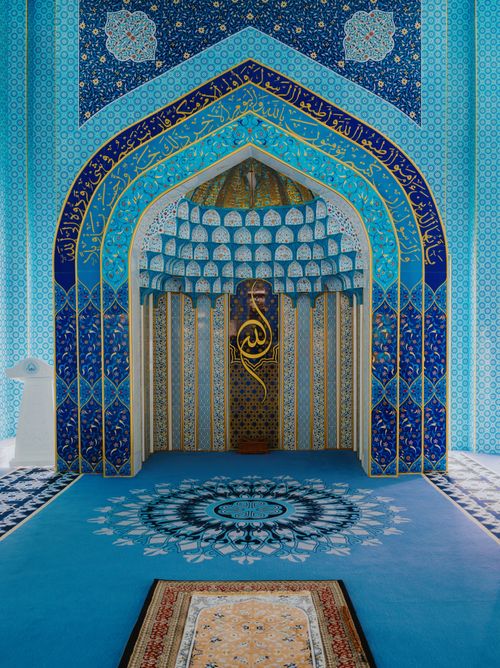 Free Intricately designed Islamic prayer area with blue and gold motifs in a Malaysian mosque. Stock Photo