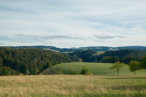 Free A beautiful view of rolling hills and forests in the Bavarian Forest, Germany, on a clear day. Stock Photo