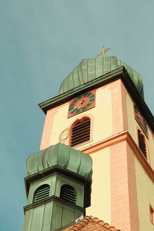Free A picturesque view of a historic church tower in BW, Germany, against a clear sky. Stock Photo