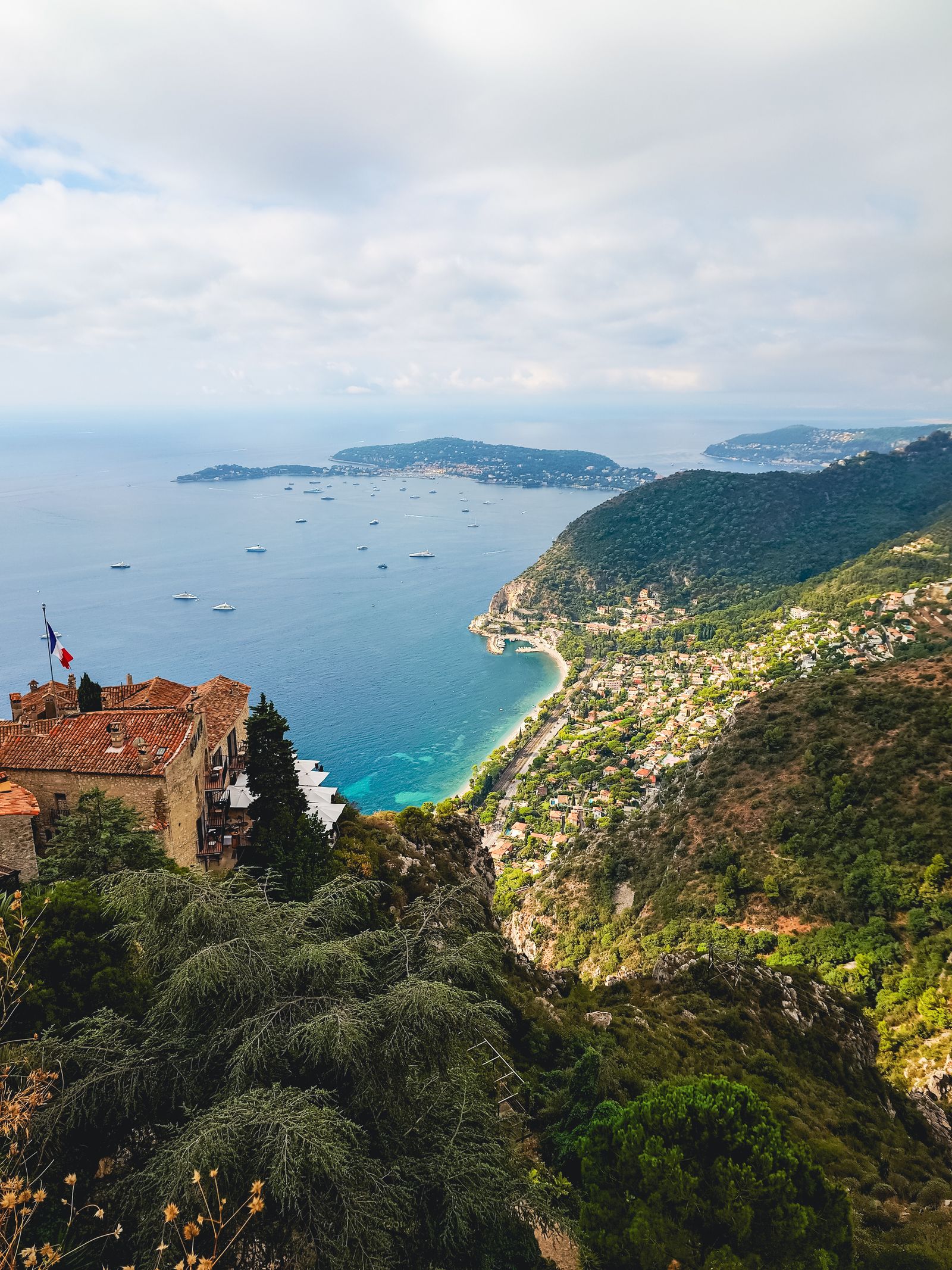 View from the perched village of Èze over pine-covered slopes to the turquoise Mediterranean and Cap Ferrat