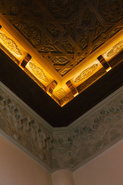 Free Detailed view of a traditional Moroccan inspired ceiling with ornate carvings and lighting. Stock Photo