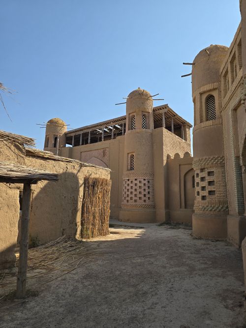 Free Ancient mud brick buildings with towers under a clear blue sky. Stock Photo