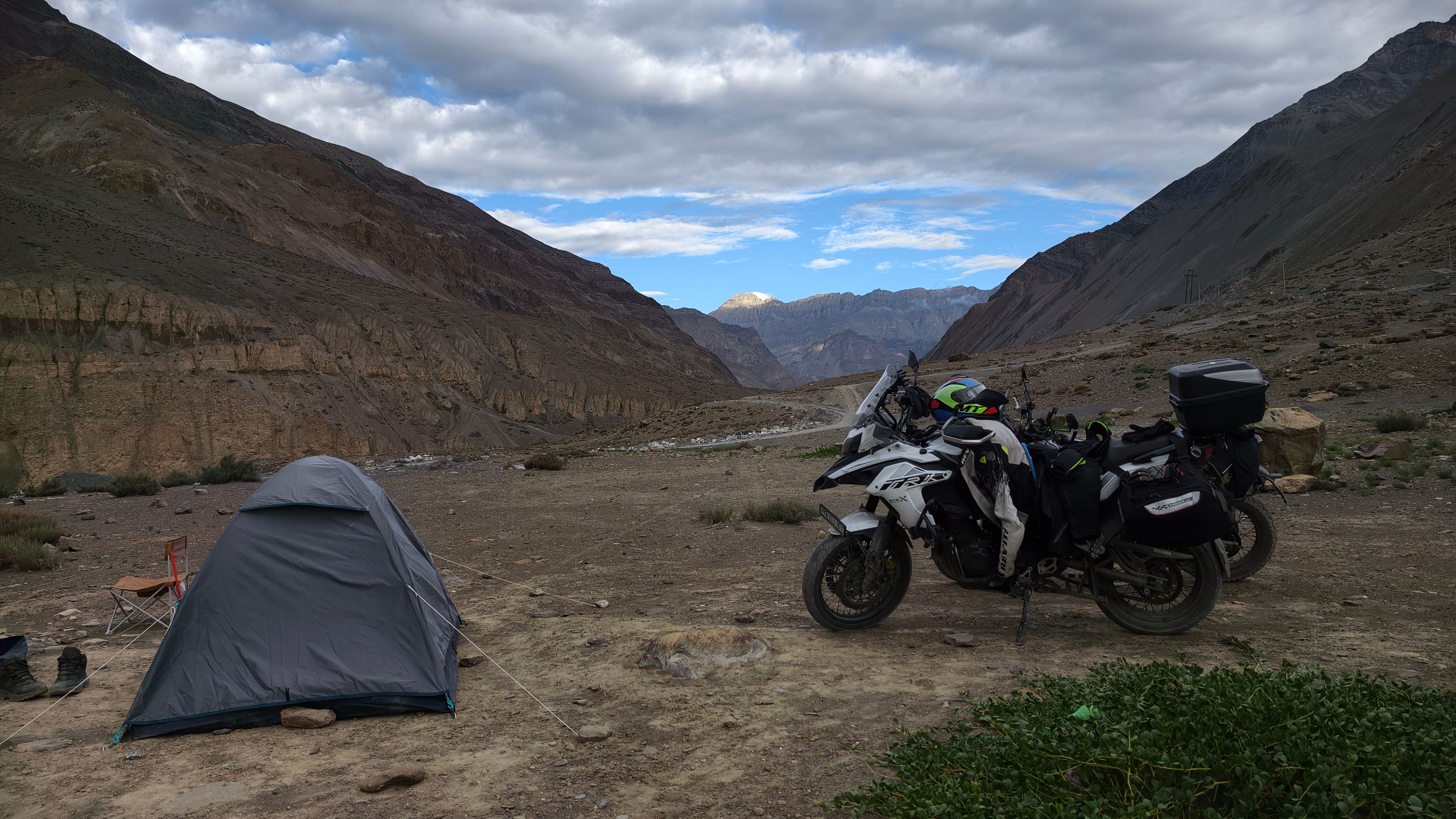 Motorcycle and tent campsite in Langza, Himachal Pradesh, India landscape.