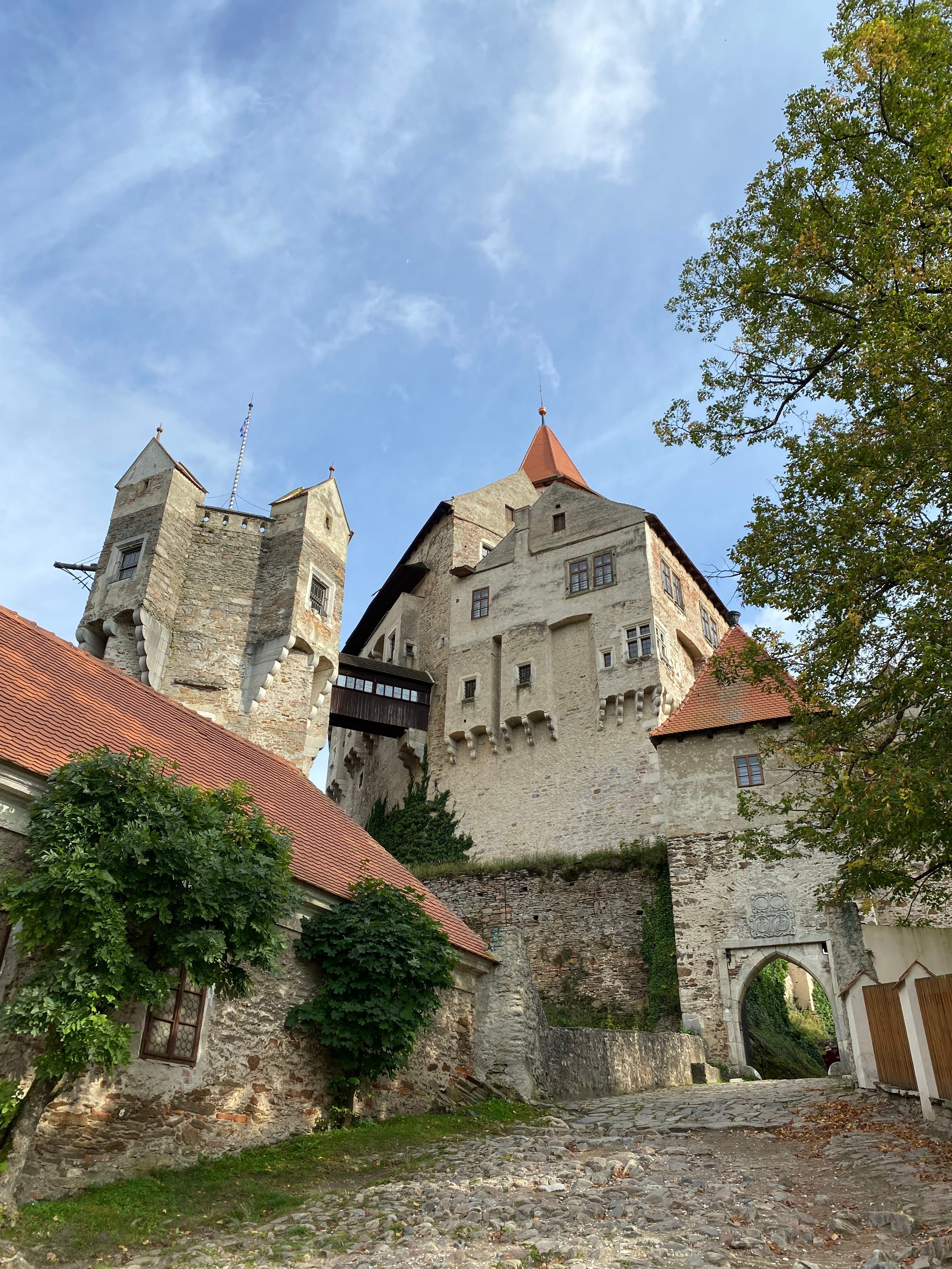 Captivating view of Bouzov Castle with clear skies and autumn foliage, historical architecture in Czech Republic.