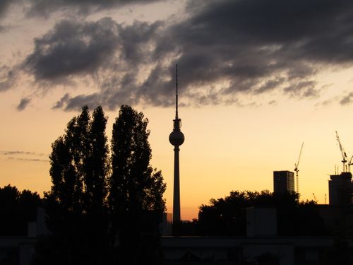 Free Silhouette of Berlin's TV Tower at sunset with city skyline and clouds. Stock Photo