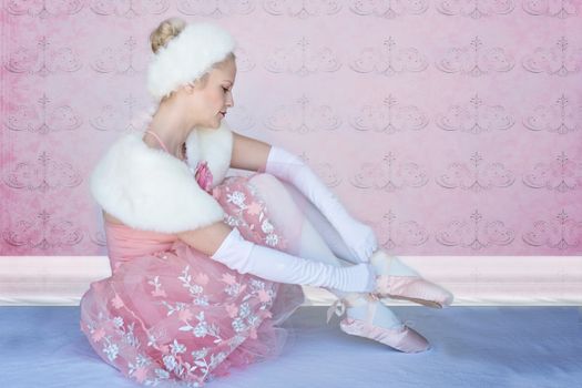 Ballet dancer in a pink floral costume with a serene pose, showcasing grace and elegance.