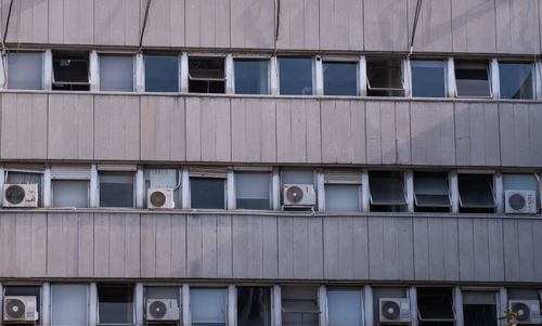 Free Exterior view of a concrete building facade in İzmir with multiple air conditioners. Stock Photo