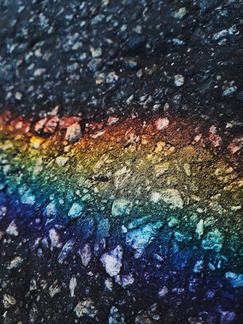 Abstract creative background of dark rough icy texture with colorful rainbow line