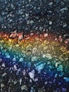 Abstract creative background of dark rough icy texture with colorful rainbow line