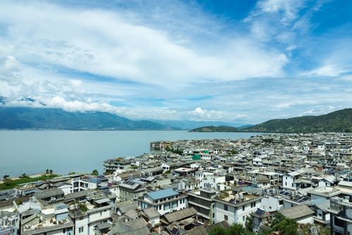 Free Scenic aerial view of Dali Old Town with Erhai Lake in the background, showcasing traditional architecture and stunning landscapes. Stock Photo