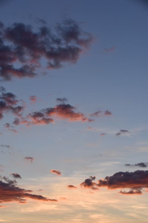 Free A vivid sunset with beautiful shades of blue and orange clouds creating a serene atmosphere. Stock Photo