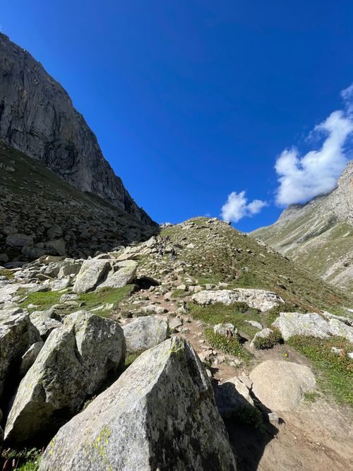 Free A breathtaking view of a mountain trail in the Himalayas under a clear blue sky. Stock Photo