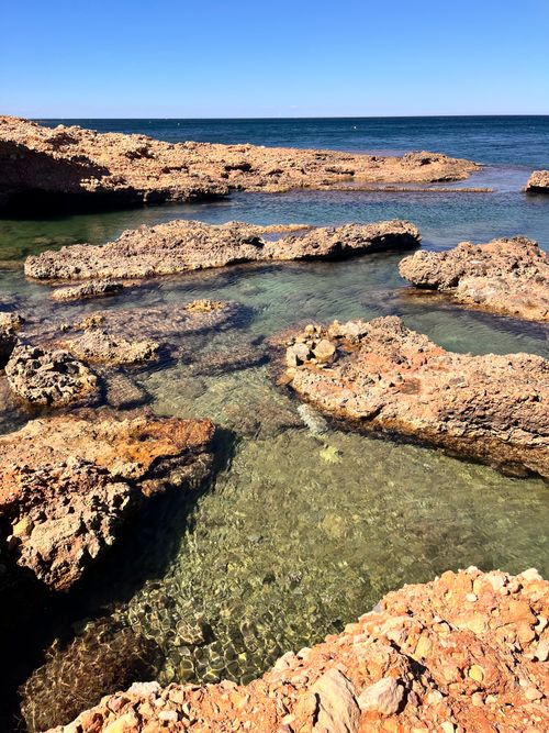 Free Beautiful rocky shoreline with clear waters along the Denia coast in Spain. Stock Photo