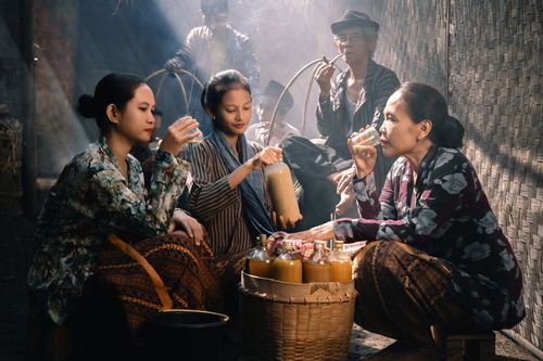 Free Women enjoying traditional Jamu drink in a market in Jawa Barat, Indonesia. Stock Photo