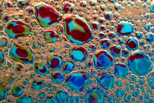 Free Vibrant macro shot of colorful soap bubbles creating an abstract texture with organic shapes. Stock Photo