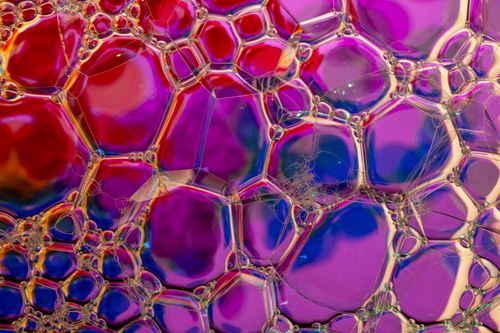 Free Colorful macro shot of soap bubbles showcasing abstract patterns and vibrant hues. Stock Photo