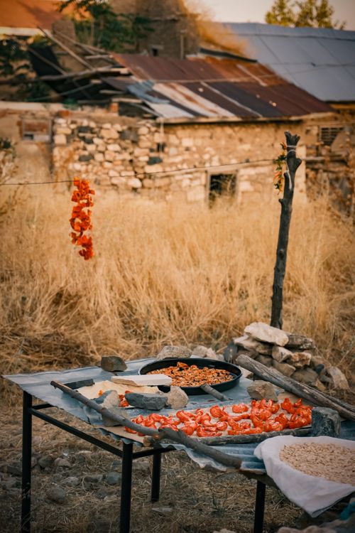 Free A rural setting with drying vegetables on a table, offering a rustic, homely feel. Stock Photo