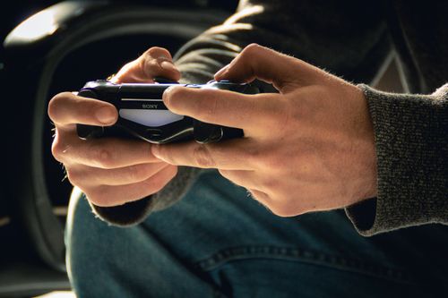 Free A close-up of hands holding a DualShock controller, perfect for gaming-related content. Stock Photo