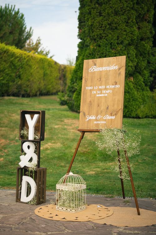Free Rustic wedding welcome sign with floral elements outdoors in Spain. Stock Photo