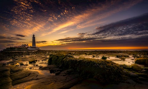 White Lighthouse During Sunset