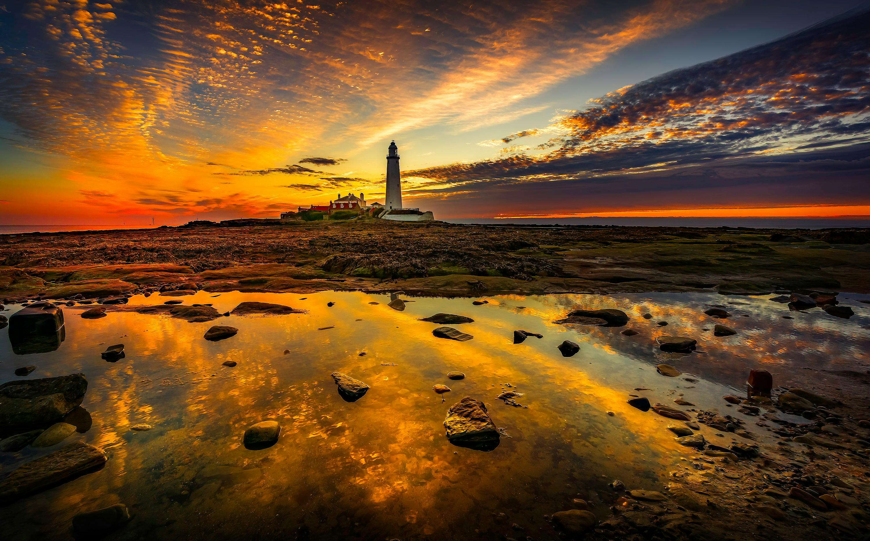 White Lighthouse On Rocky Shore During Sunset · Free Stock Photo