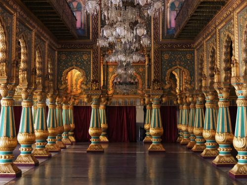 Free Luxurious gold and teal pillars in the Durbar Hall of Mysore Palace, showcasing Indian royal architecture. Stock Photo