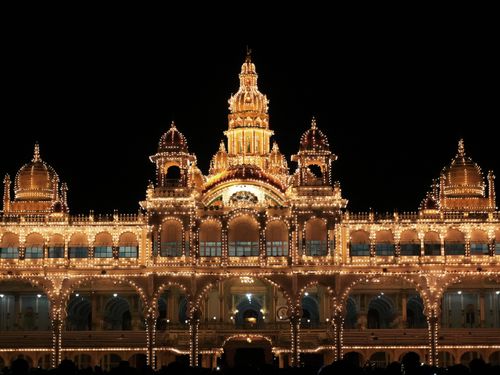 Free Dazzling night view of the Mysore Palace adorned with sparkling lights, showcasing rich Indian architecture. Stock Photo