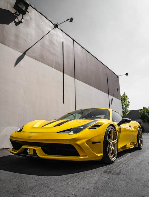 Free Yellow Sports Car Parked Near A Wall Stock Photo