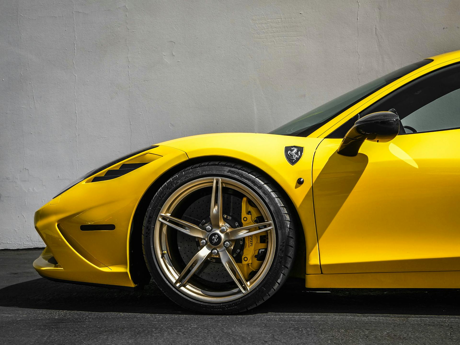 Yellow Ferrari 458 Italia Parked Near White Wall