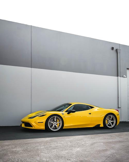 Yellow Ferrari 458 Italia Parked Beside Gray Wall