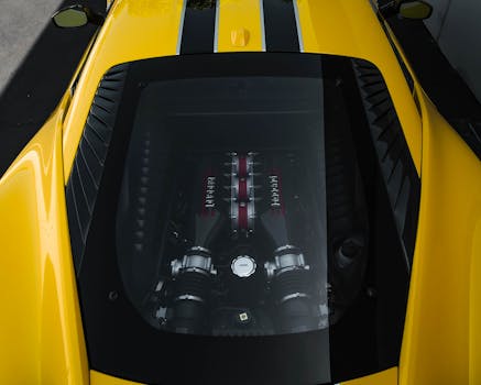 Top-down view of a luxurious sports car showcasing its powerful engine under a transparent hood.