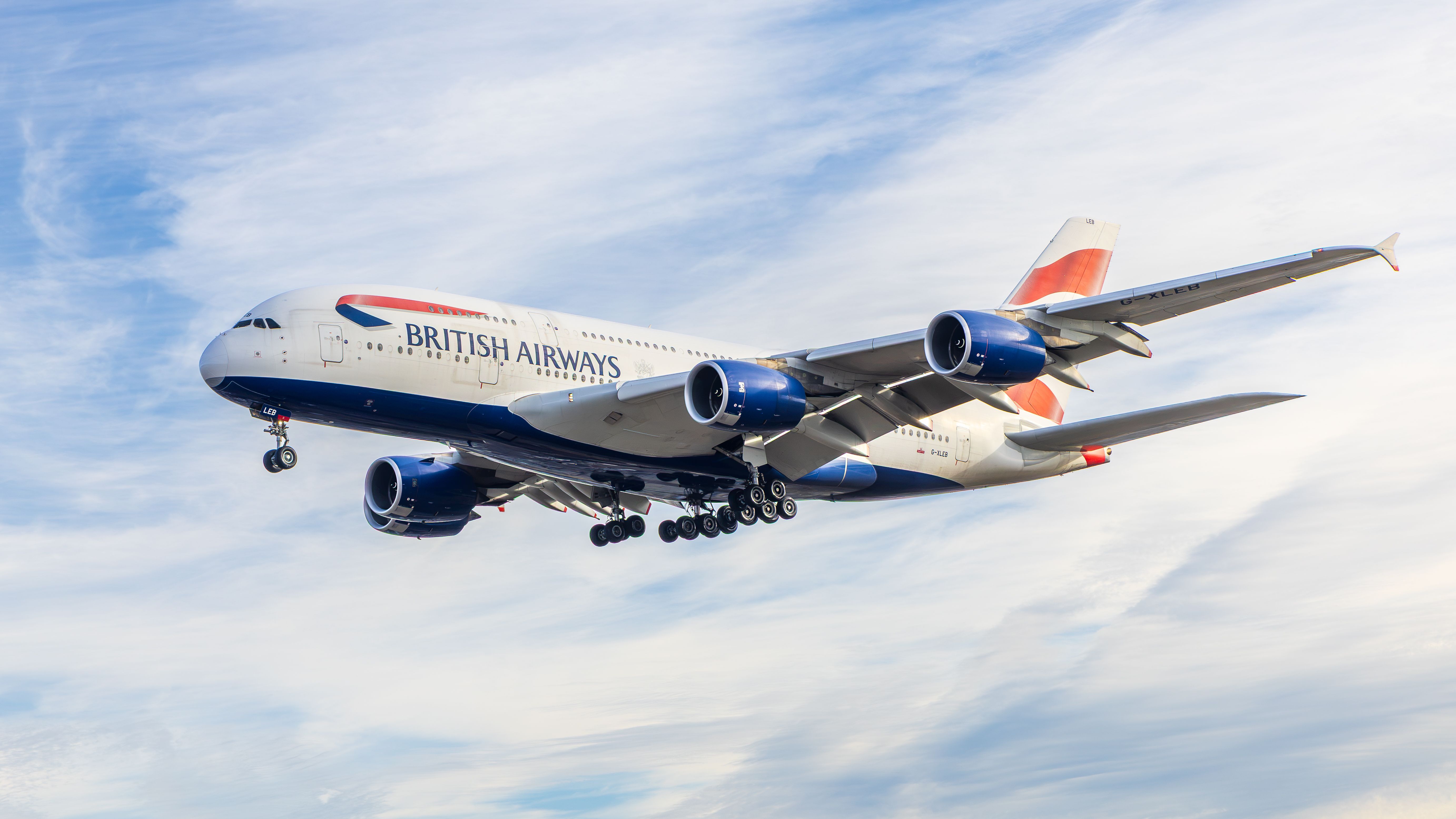British Airways Airbus A380 flying under blue skies in England, UK.